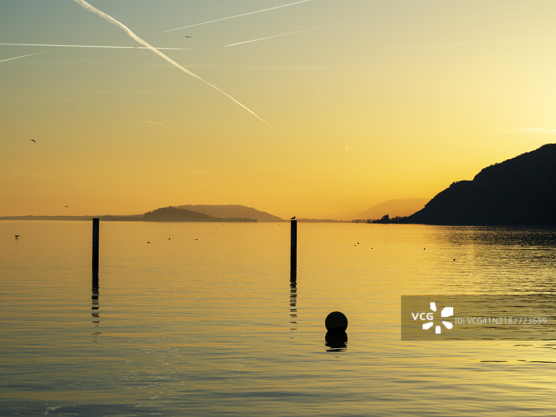 冬季比尔湖的水面上，夕阳的光辉映照着远处的圣彼得岛。图片素材