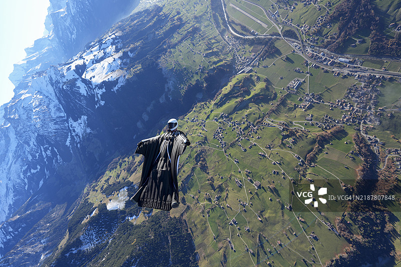 翼装飞行者在雪山之上翱翔图片素材