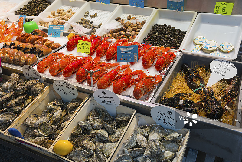 市场摊位上精心摆放的各种海鲜，如龙虾和生蚝，鱼市，特鲁维尔-苏尔-梅，特鲁维尔，诺曼底，法国，欧洲图片素材