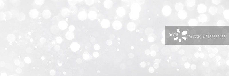 灰色背景上的白色模糊闪光波光灯光横幅图片素材