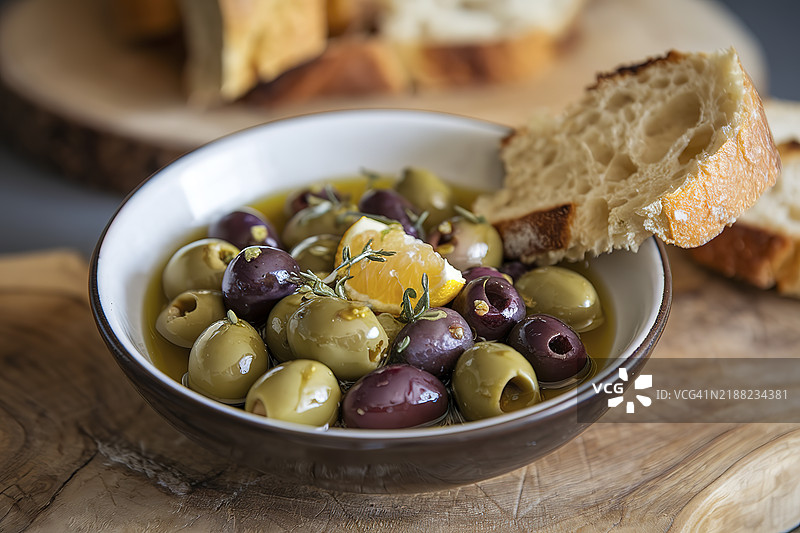 一碗装满绿色和紫色橄榄的混合物，浸泡在橄榄油中图片素材