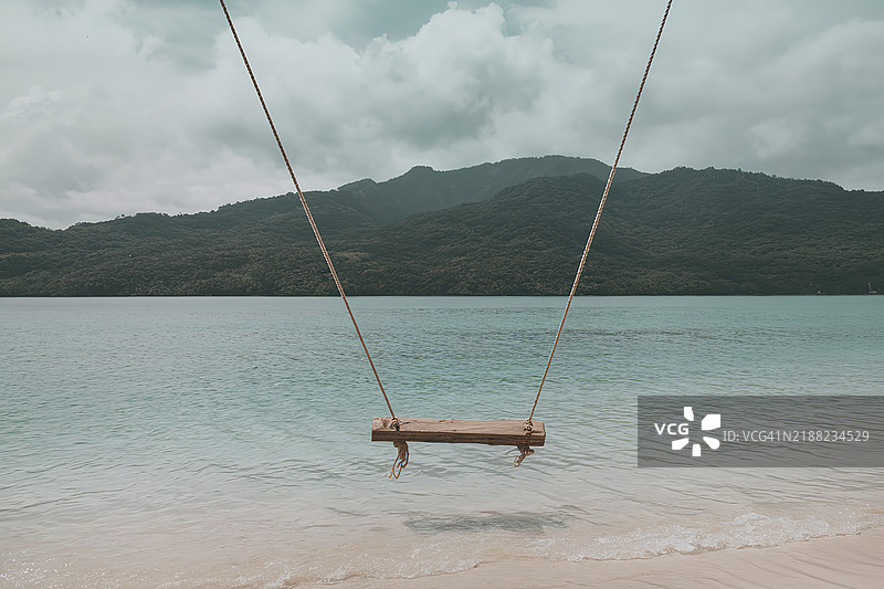 宁静的海岸景色，广阔的清澈碧绿海水轻轻拍打着沙滩。图片素材