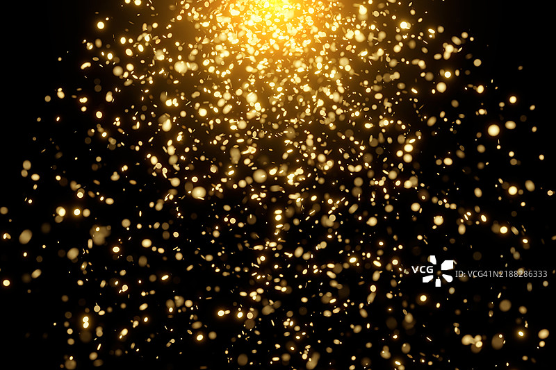 黑色背景上的闪闪发光的金色颗粒。时尚节日金色的圣诞和新年概念图片素材