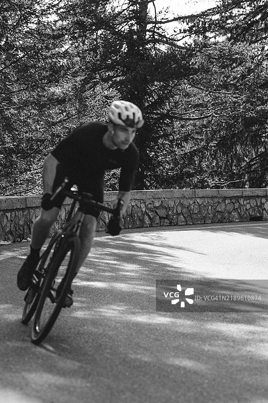 春季在德国巴伐利亚的阿尔高，公路自行车骑行者在阿尔卑斯山的如画背景下骑行。图片素材