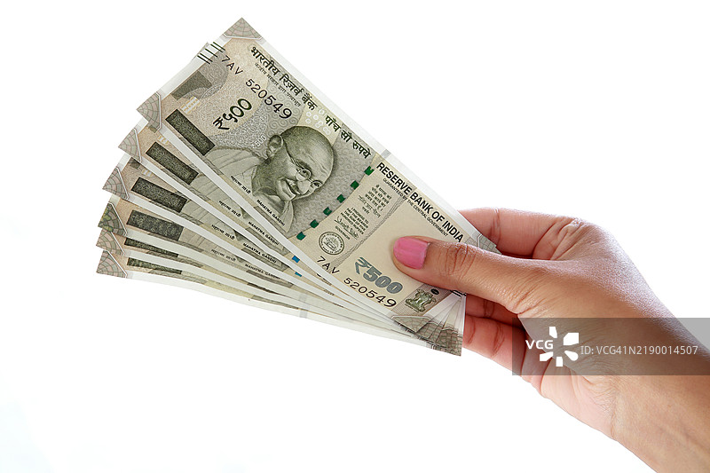 手持500卢比钞票，背景为白色图片素材