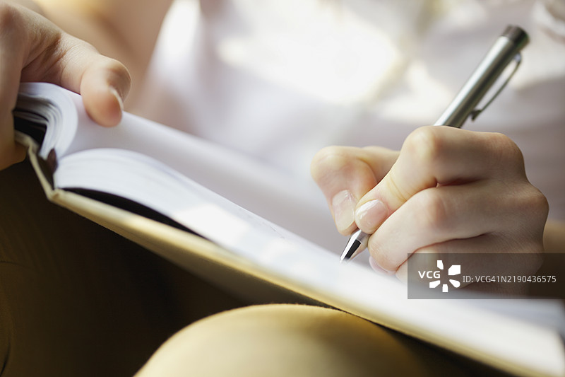 女人的手、钢笔和书籍图片素材