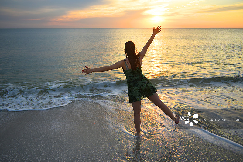 在美国佛罗里达州的海滩上日落时锻炼。图片素材