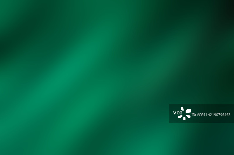 绿色运动模糊背景。清新的翡翠光波。绿色渐变流动的宁静。自然色调的抽象和谐。一场生机勃勃的绿色交响曲。图片素材