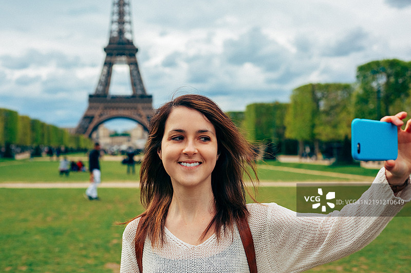 在巴黎的女人在埃菲尔铁塔前自拍图片素材