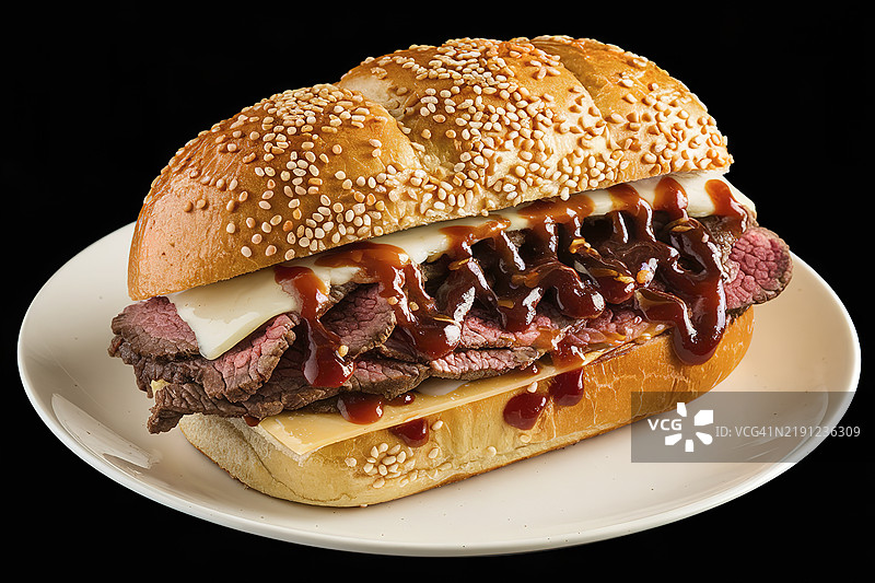 一款美味的三明治，里面满满都是牛肉片，淋上了烧烤酱。图片素材