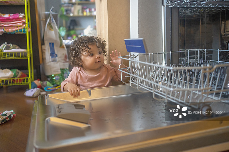好奇的宝宝在探索洗碗机图片素材