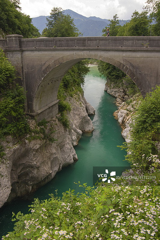 一个人在斯洛文尼亚戈里什卡科巴里德的索恰河上的拿破仑桥上。图片素材