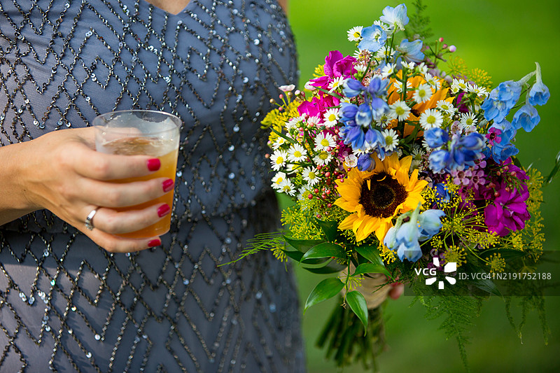 女人手持鲜花和饮料图片素材