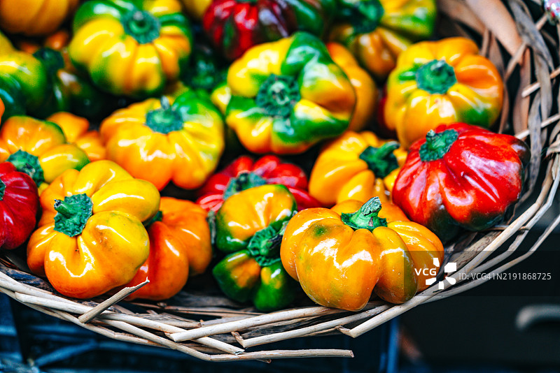 五彩缤纷的彩椒在藤编篮子中展示图片素材