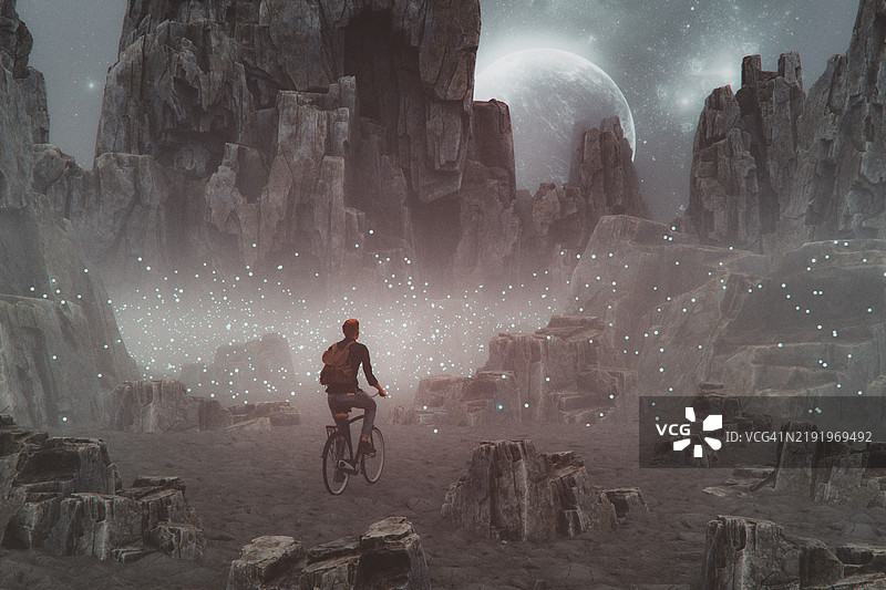 在幻想风景中骑自行车的男人图片素材