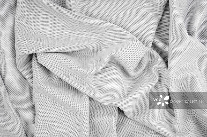 皱褶的灰色布料纹理，作为背景的抽象图案。图片素材