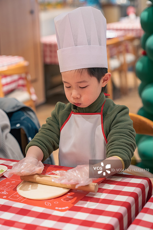 一个孩子在制作披萨图片素材