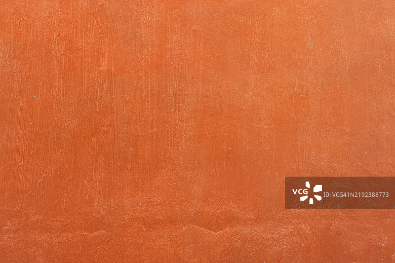 质朴的橙色抹灰墙，带有纹理和自然色调背景图片素材