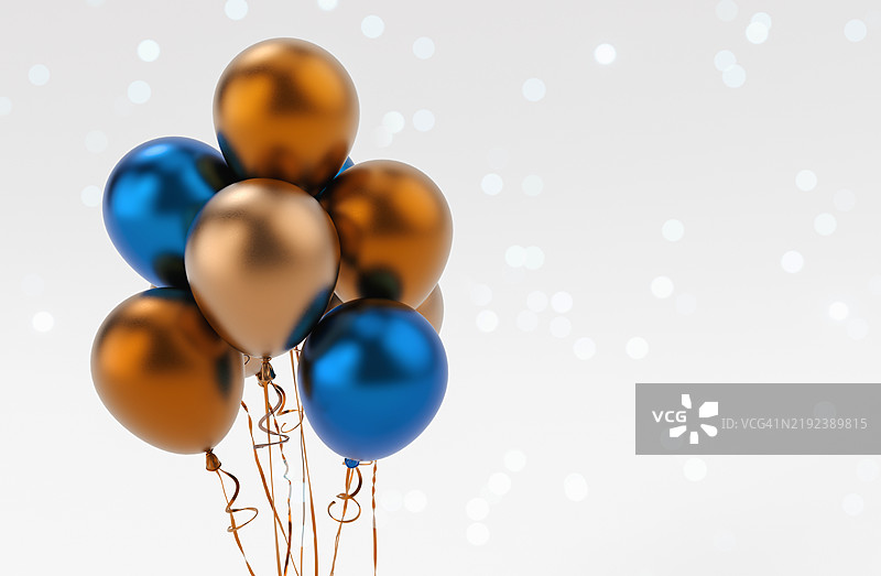 节日背景，特写镜头展示金棕色和蓝色气球漂浮在灰白渐变背景上图片素材