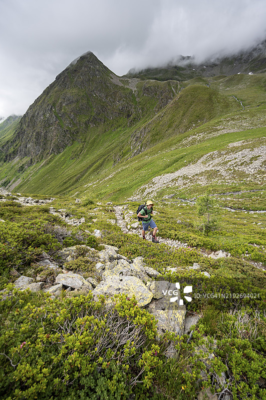 在奥地利东蒂罗尔的拉索尔林山脉,穆利茨塔尔的徒步小径上,一名登山者正在攀登从维尔根塔尔到拉索尔林小屋的路线。图片素材