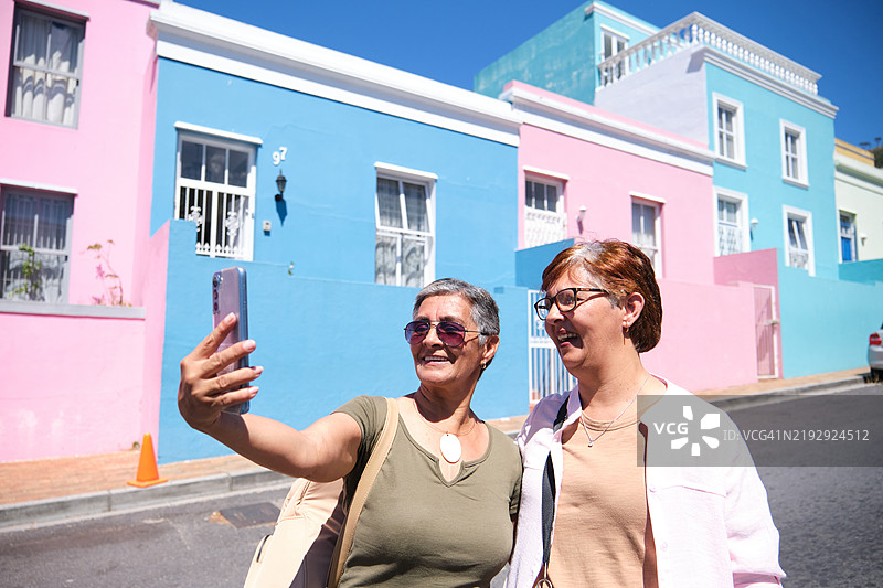 两位老年朋友在拍自拍肖像。图片素材