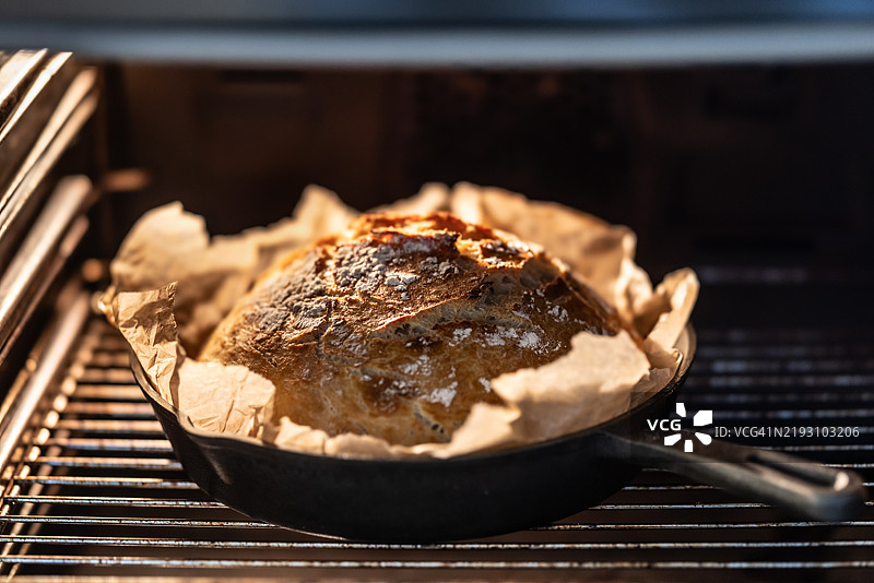 自制面包在铸铁锅中烘烤。图片素材