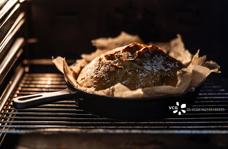 自制面包在铸铁锅中烘烤。图片素材