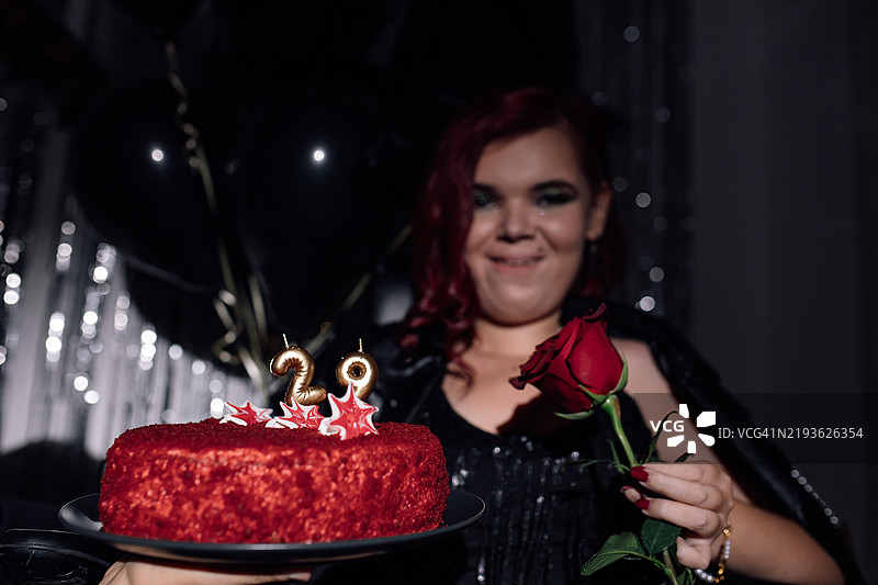 在节日氛围中庆祝里程碑式的生日，搭配红丝绒蛋糕和玫瑰花图片素材