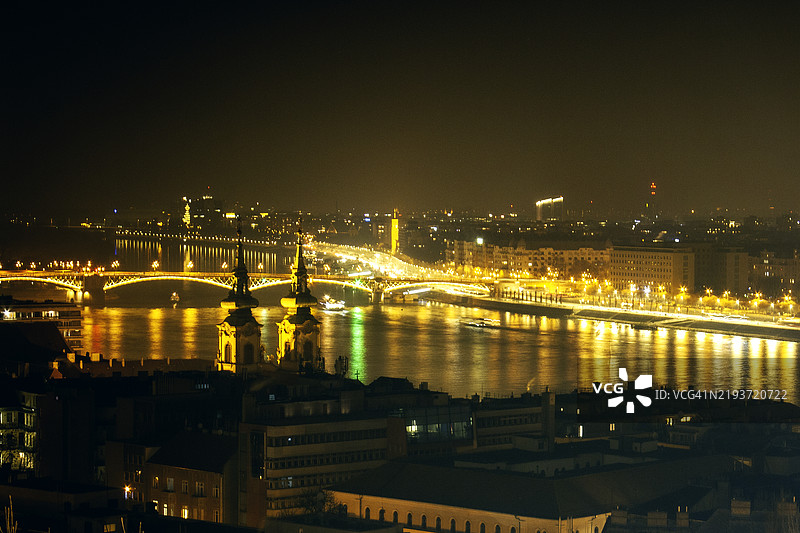 High angle view of illuminated buildings by river at night图片素材