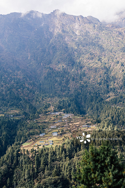 尼泊尔山地风景的广角镜头，山上有一个小村庄。图片素材