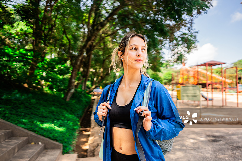 年轻女性在公园里走动并四处张望图片素材