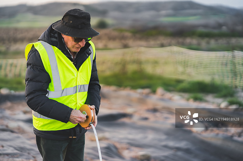 考古学家在挖掘现场使用卷尺图片素材