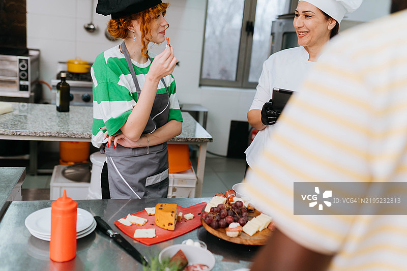 厨师在烹饪课堂上协助学员图片素材