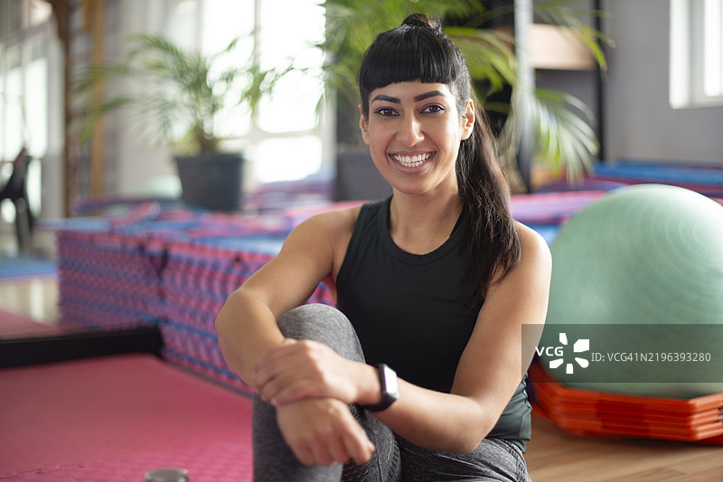 快乐的女性瑜伽教师肖像，教授正念和健康。微笑的女性教练和灵性疗愈、整体辅导与禅意平衡的学习中心。图片素材