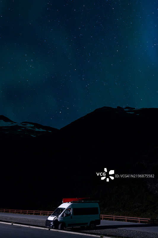 在挪威观看北极光时停放在停车场的露营车图片素材