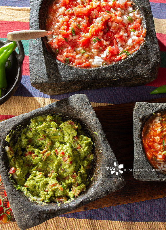 三种石碗中的莎莎酱：辣椒佩布雷酱、鳄梨酱和番茄莎莎。拉丁美洲墨西哥和智利美食。图片素材