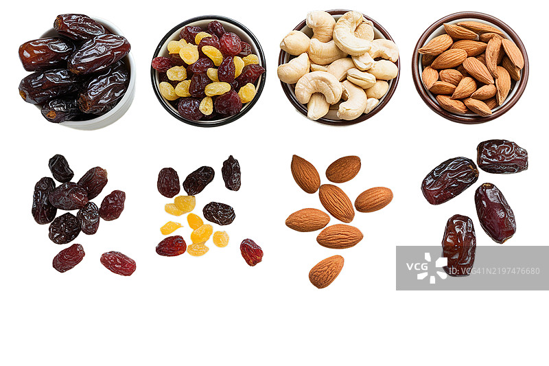 白色木质背景上的干枣、葡萄干、腰果和杏仁图片素材