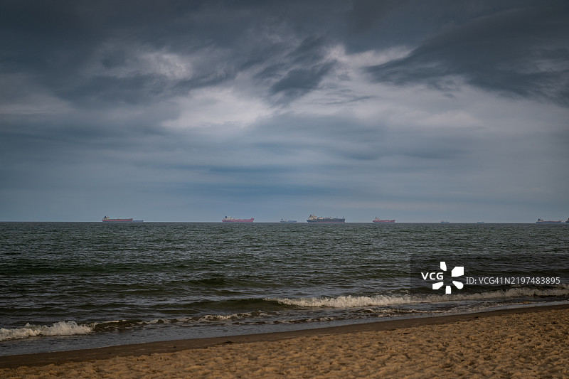 在阴云密布的傍晚，从格雷嫩海滩看到的斯卡根附近的货船排队。图片素材