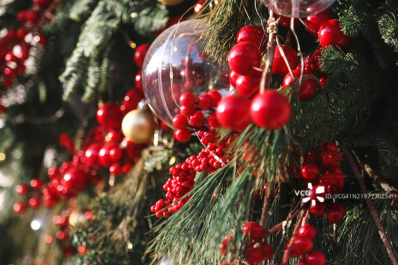 全景节日圣诞花环。常青树枝配以闪亮的花环、红色珠子和五彩缤纷的装饰球。图片素材
