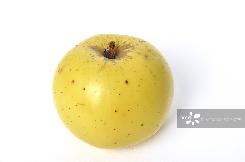 一只带有小斑点的黄色苹果，背景为白色图片素材