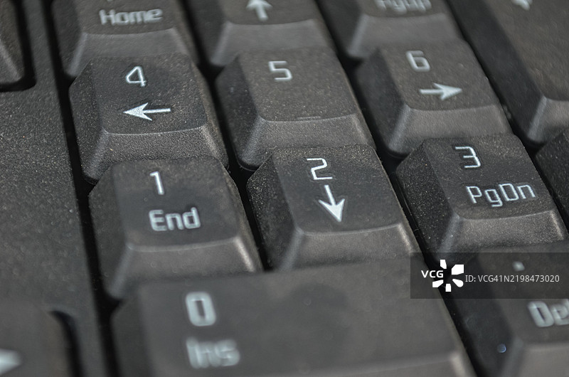 办公室的电脑键盘从未清洁或消毒，键盘上布满了灰尘。图片素材