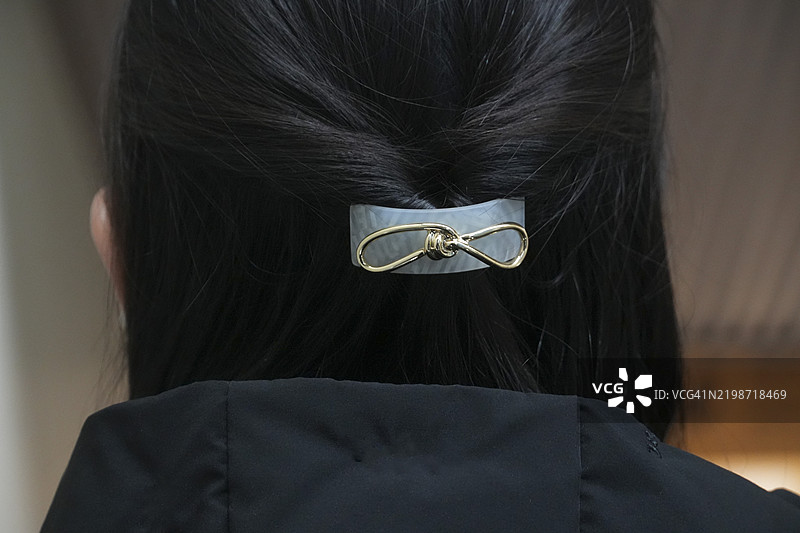 优雅的无限 ∞ 发夹在深色头发上图片素材