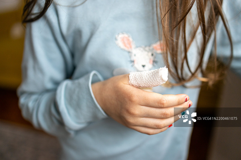 儿童手部包扎绷带在大拇指上图片素材