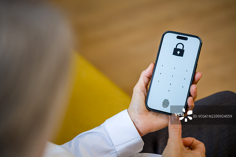 女性使用指纹解锁手机以确保安全图片素材