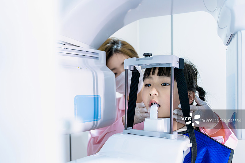 牙医/技师正在给小女孩拍牙齿X光片图片素材