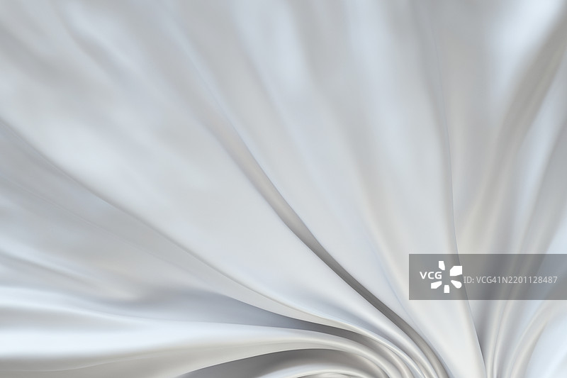 优雅流动的白色织物纹理背景，带有光滑的褶皱和波浪。图片素材