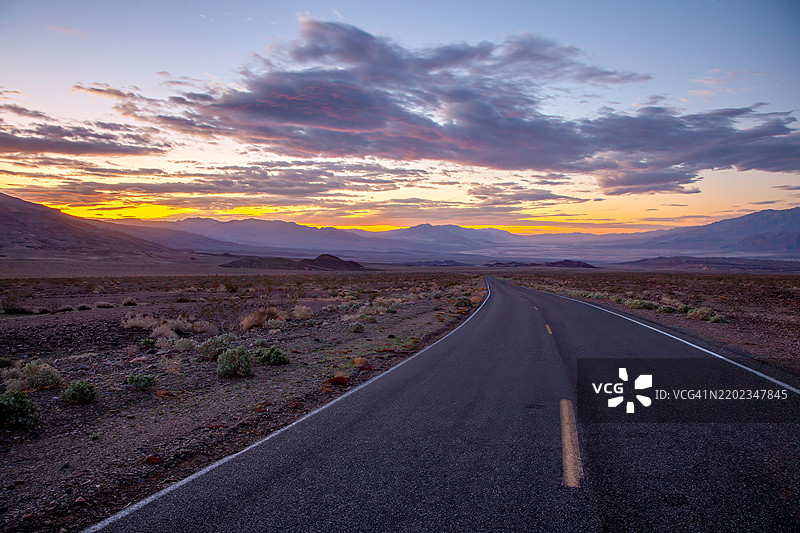 日落时分的风景沙漠公路，五彩斑斓的云彩和山脉背景，炉子溪，加利福尼亚州，美国图片素材