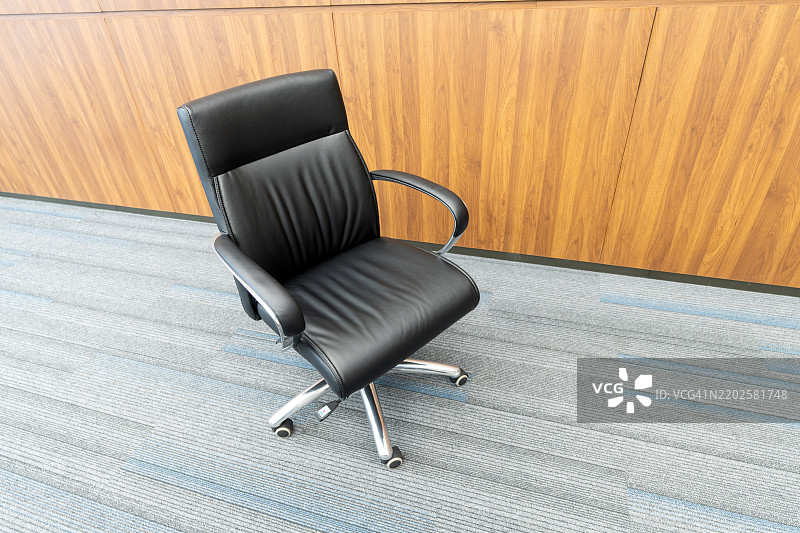 黑色皮革办公椅放在地毯上图片素材