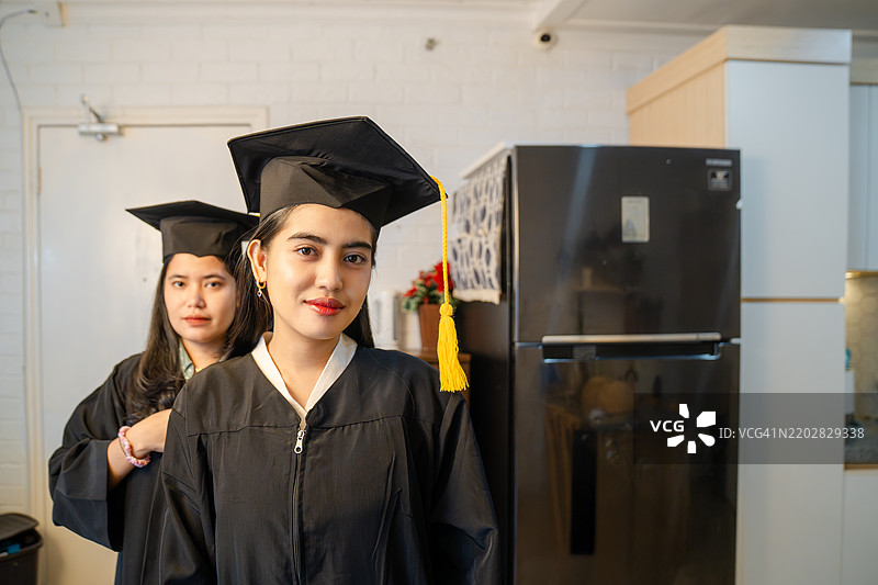 两位年轻女性穿着毕业袍图片素材