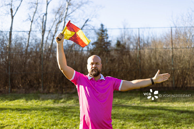 裁判在户外足球比赛中用旗子示意图片素材